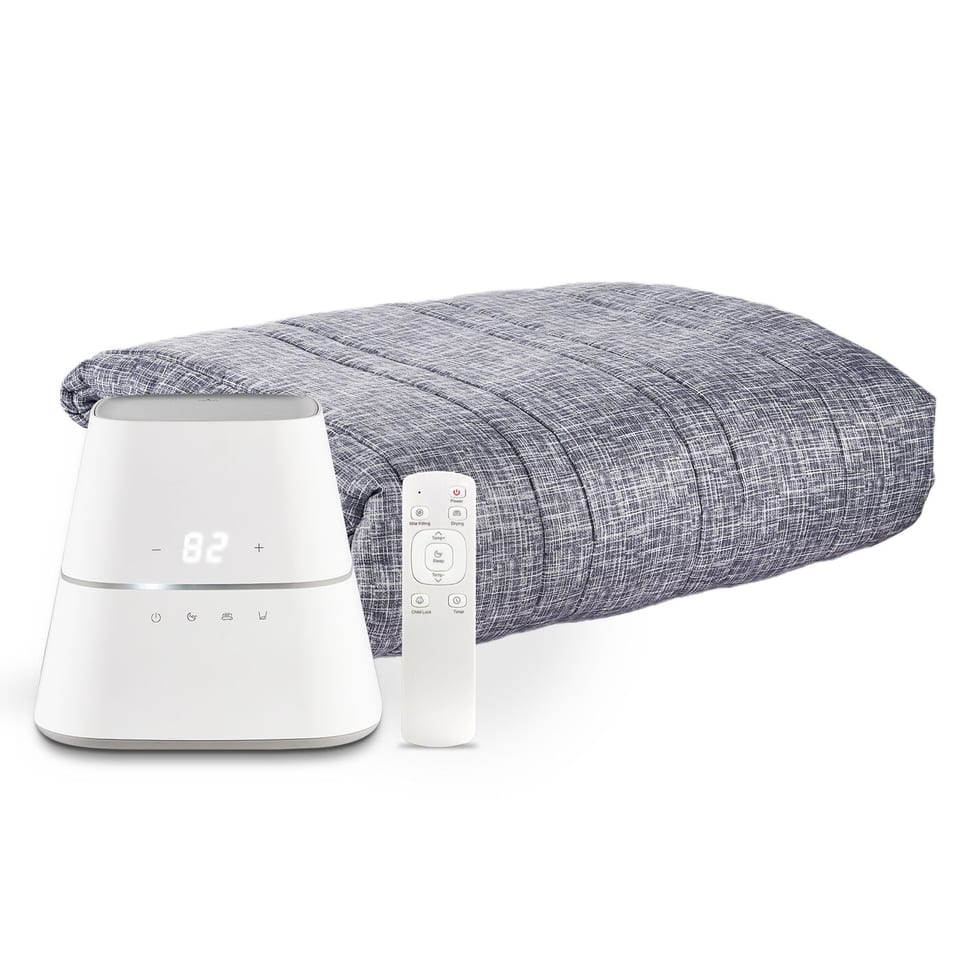 AquaPad CozyFlow water-heated mattress pad on a made bed